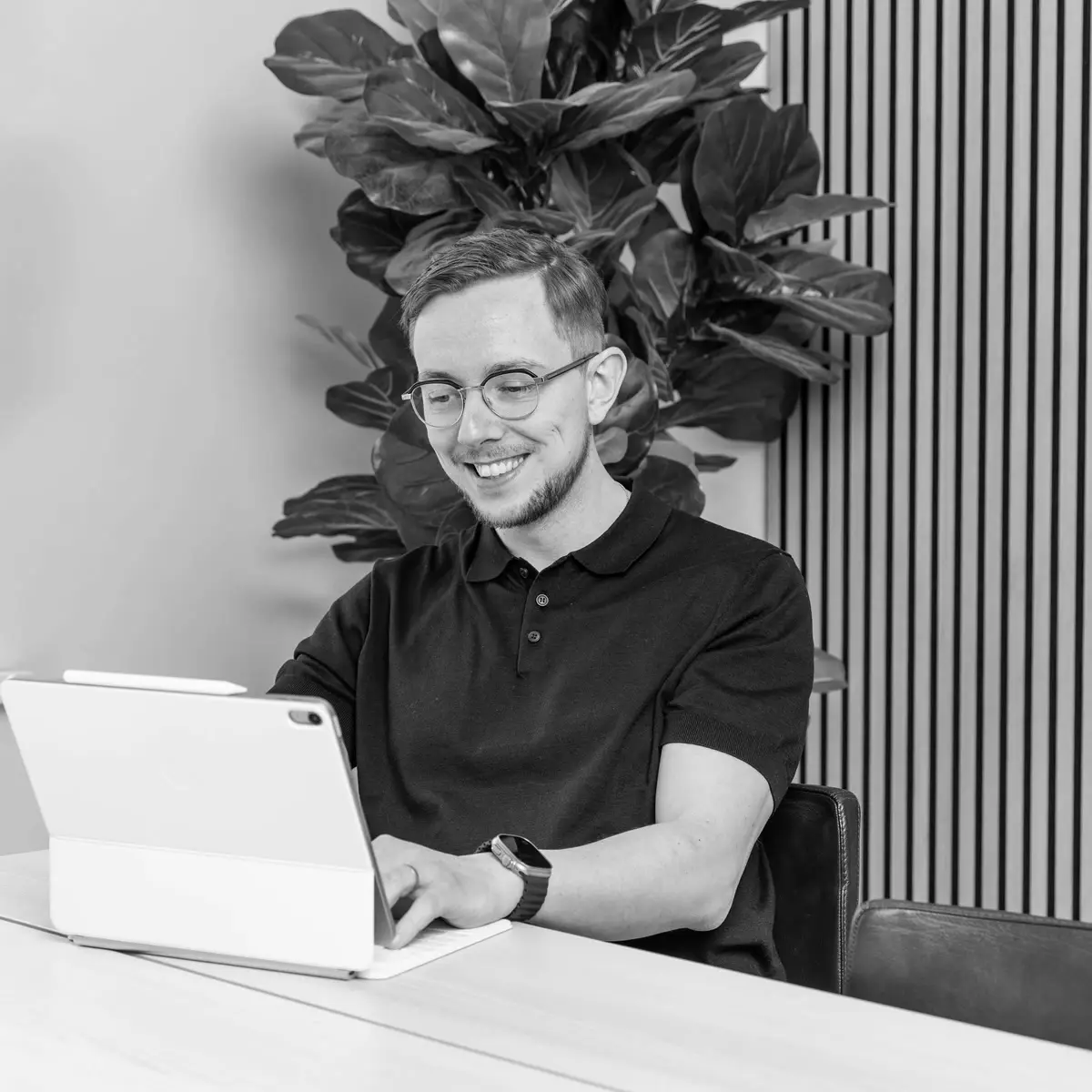 Michael Andersen smiling while he works on a laptop